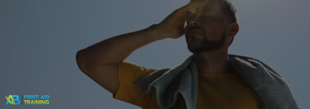 Man outdoors, sweating under the summer heat.