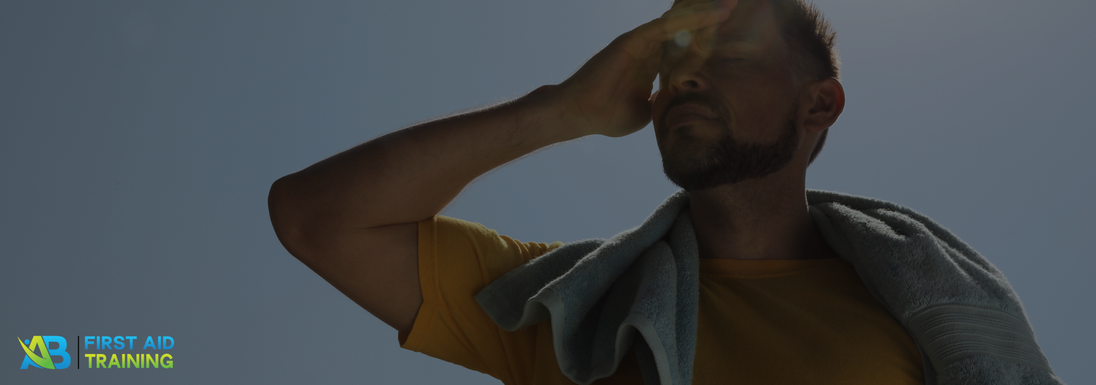 Man outdoors, sweating under the summer heat.