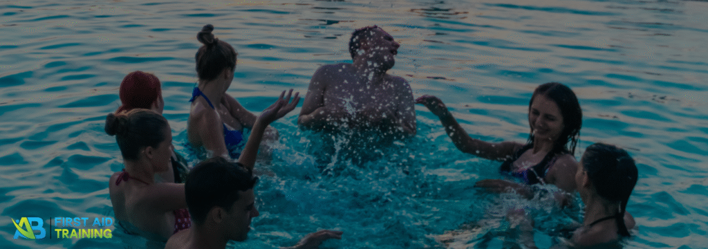 People having fun in a pool on a sunny day.